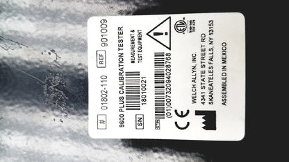 White rectangular label on welch allyn 9600 plus calibration tester showing model number serial number and certification marks