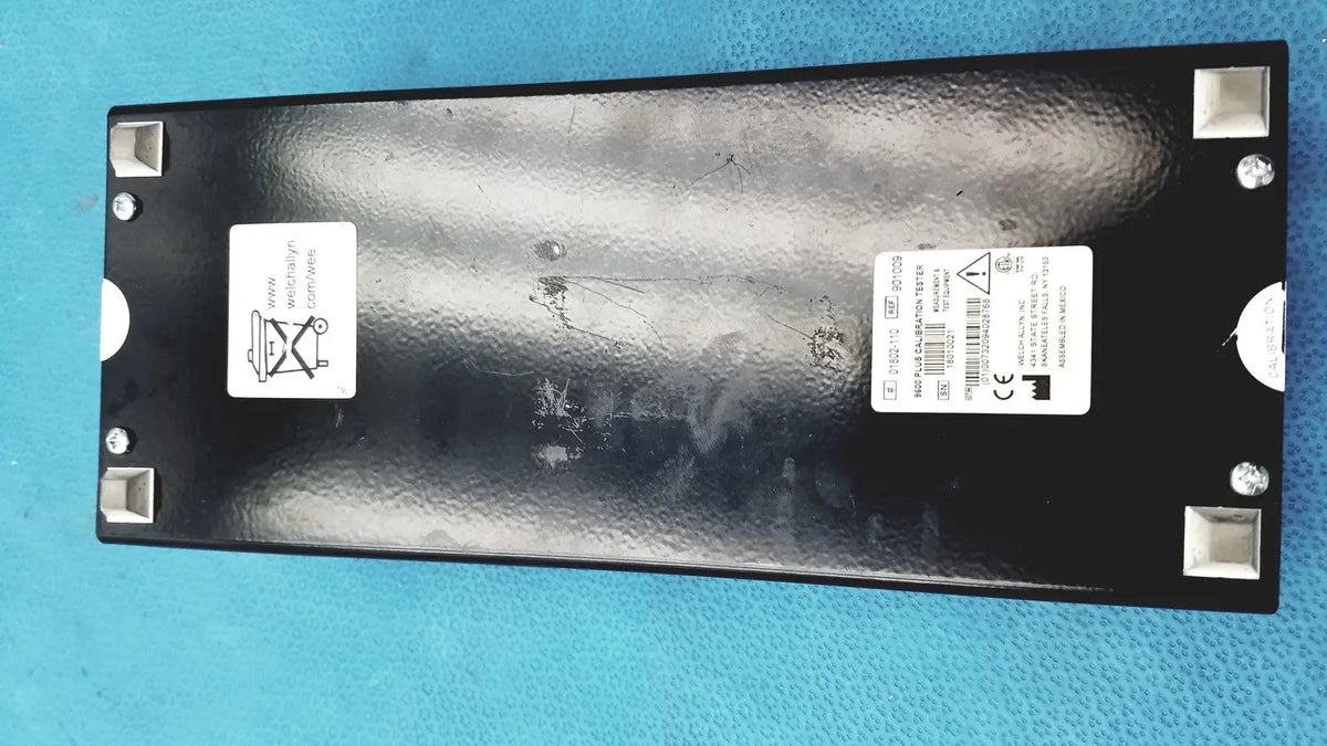 Black rectangular welch allyn 9600 plus calibration tester with textured surface and silver corner protectors