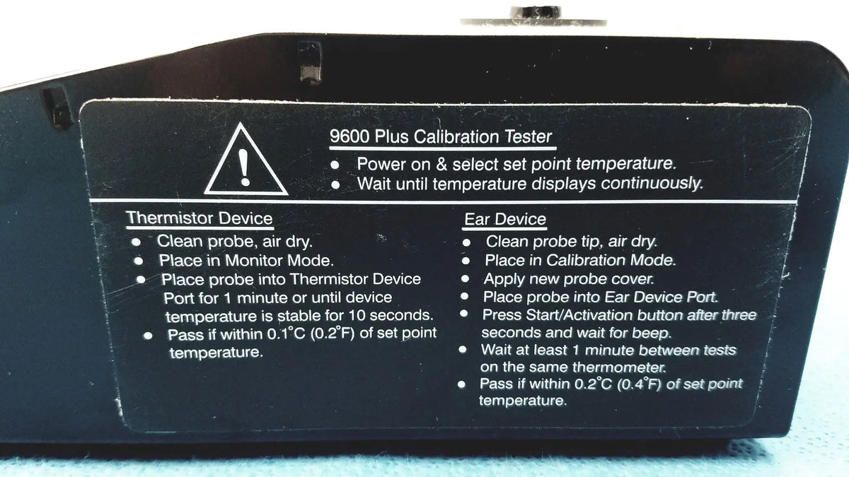 Black plastic welch allyn 9600 plus calibration tester with white printed instructions and warning label visible