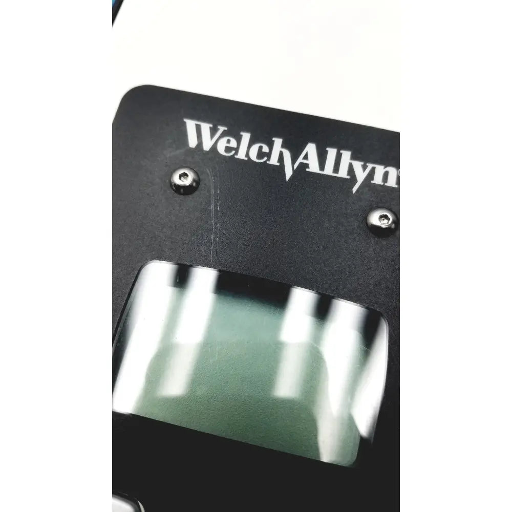 Black welch allyn plus calibration tester with rectangular transparent window and silver screws on medical device