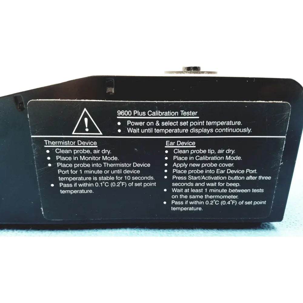 Black plastic welch allyn 9600 plus calibration tester with white printed instructions and warning label visible