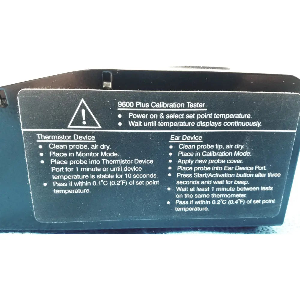 Black Welch Allyn 9600 plus calibration tester with white instructional text and warning triangle for precise plus calibration