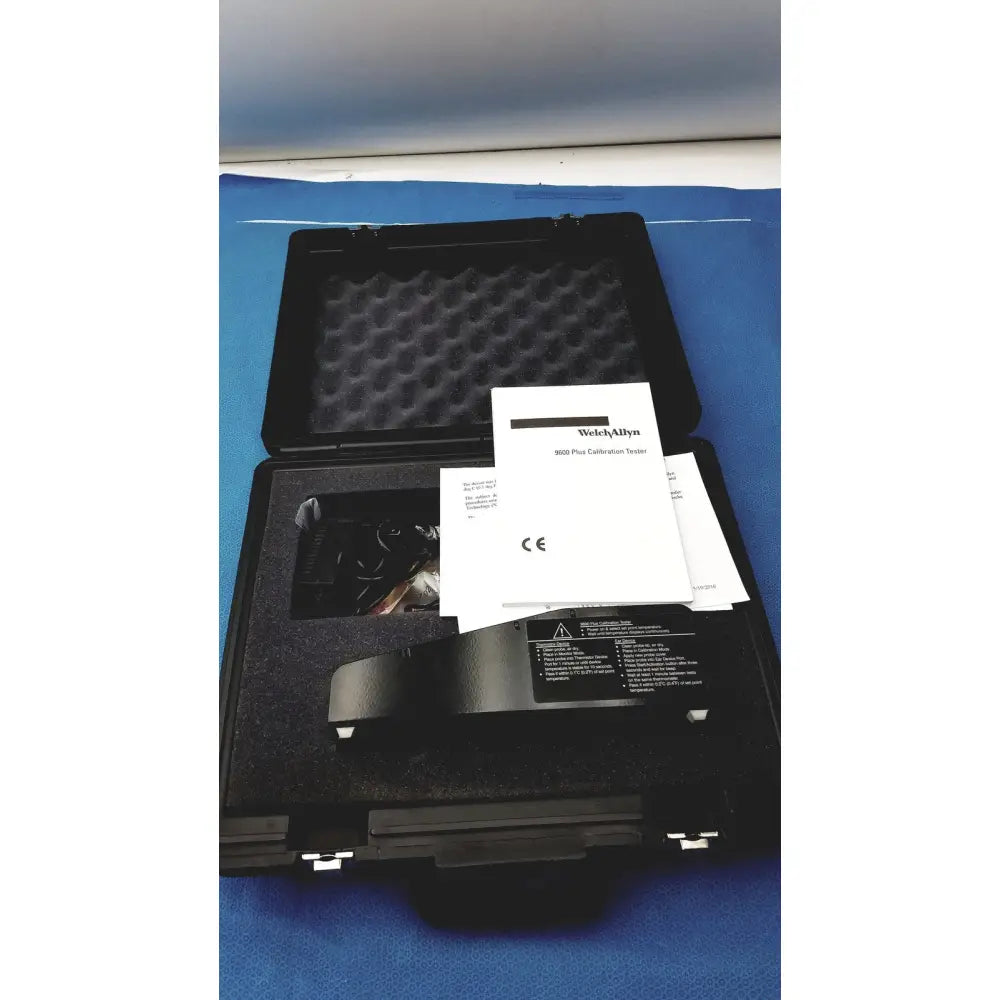 Black welch allyn 9600 plus calibration tester in protective foam-lined case with instruction manual and adapter