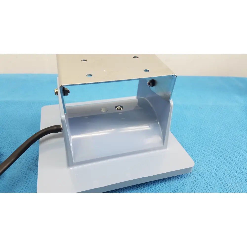 Silver metallic industrial mounting bracket with bolted connections and black cable for welch allyn adult blood presure cuff