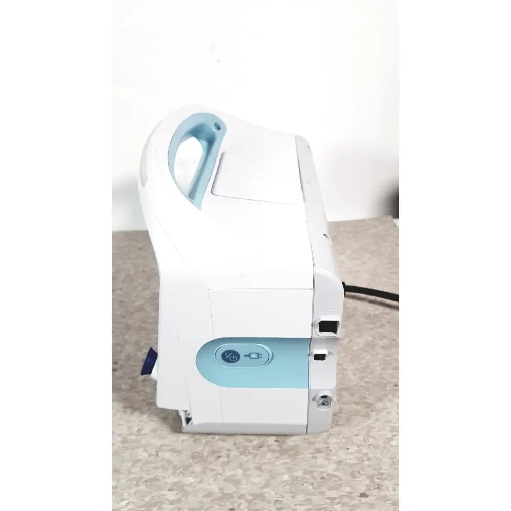 White and light blue welch allyn connex 6000 series vital signs monitor with handle for medical ventilator use