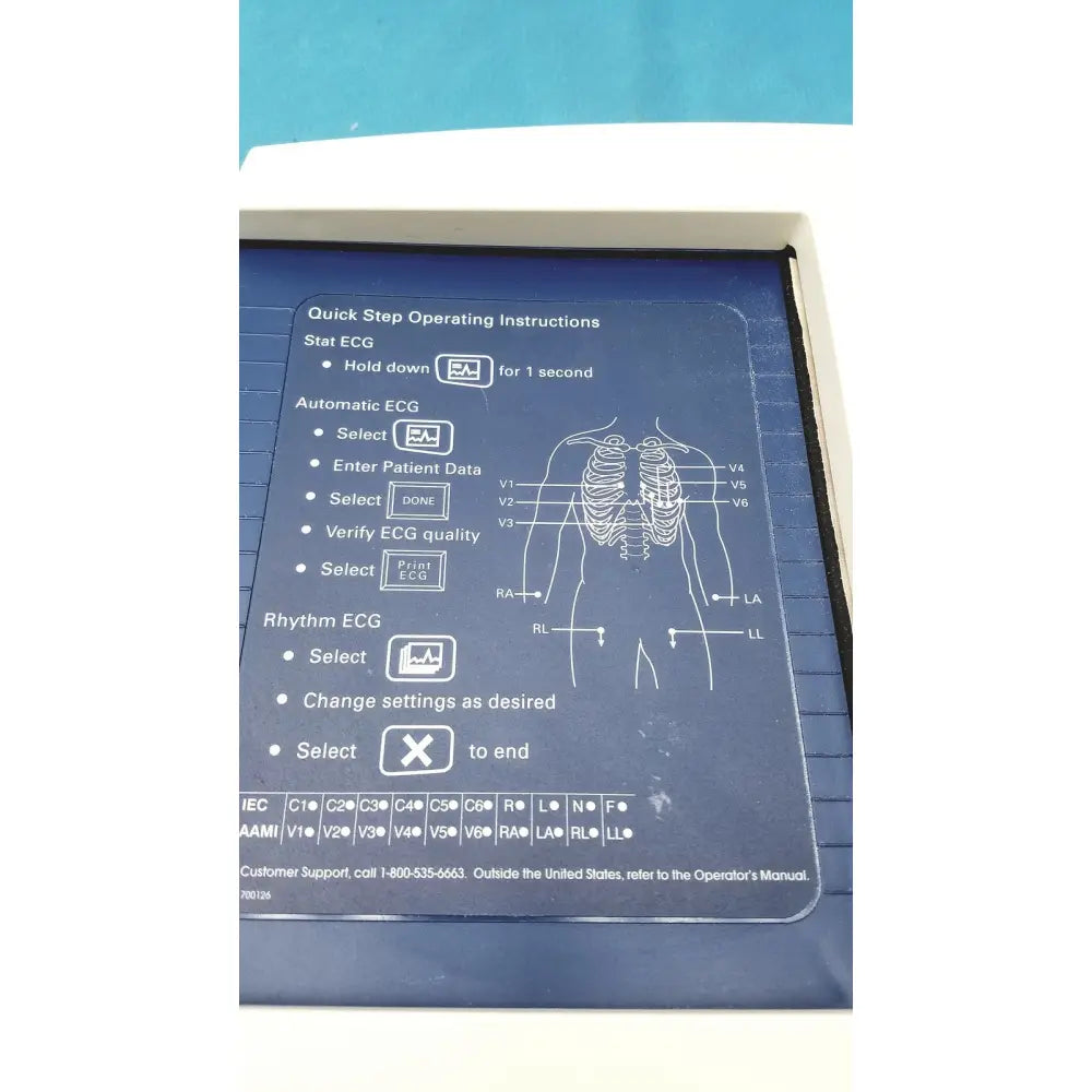 Blue plastic panel with white instructions and diagram on the back of welch allyn cp 200 ekg ecg monitor