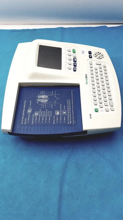 White welch allyn cp 200 ekg ecg monitor with blue display screen, labeled buttons, integrated keyboard for diagnostics