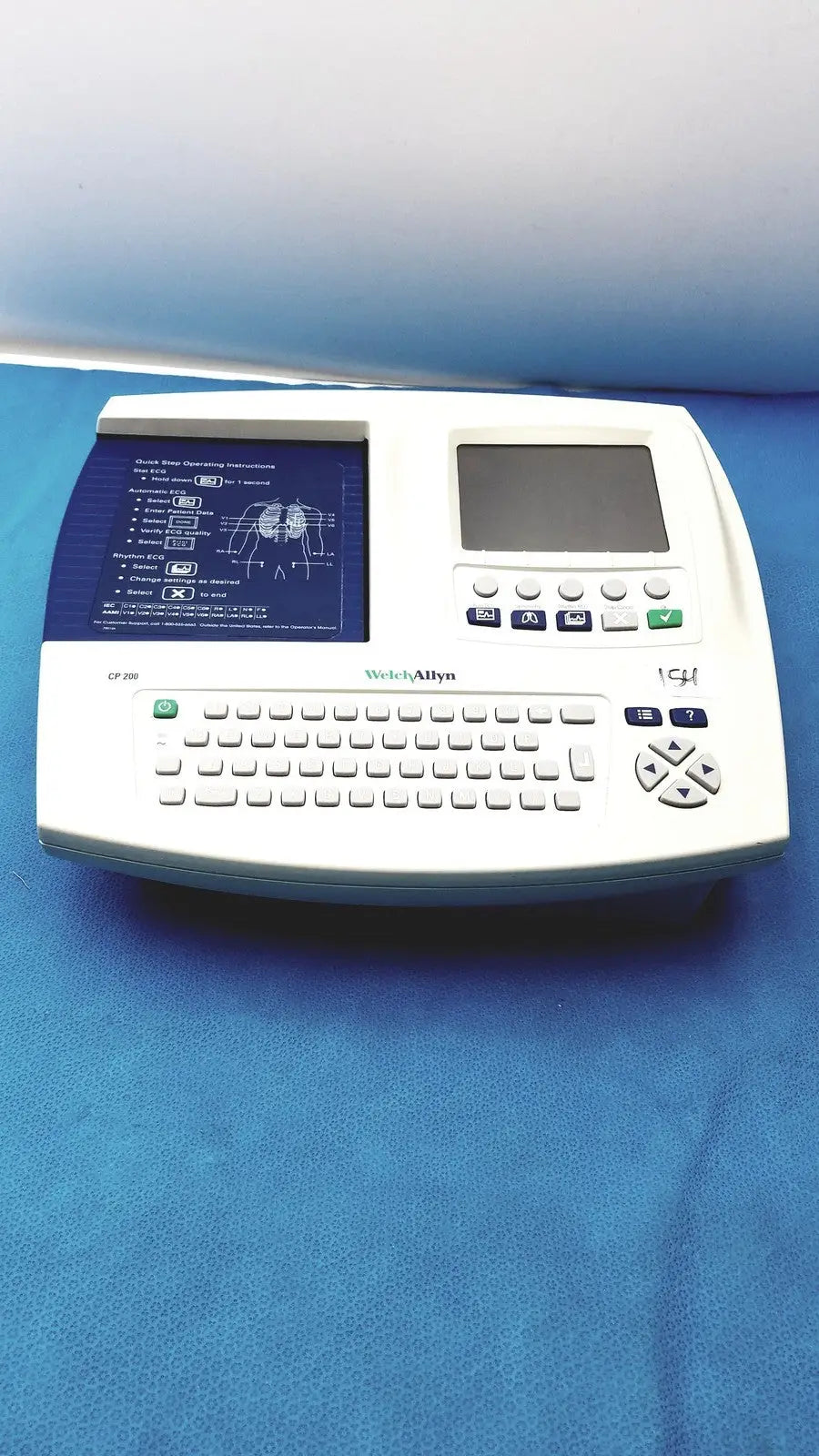 White welch allyn cp 200 ekg ecg monitor with built-in keyboard, small screen, and printed ecg display panel