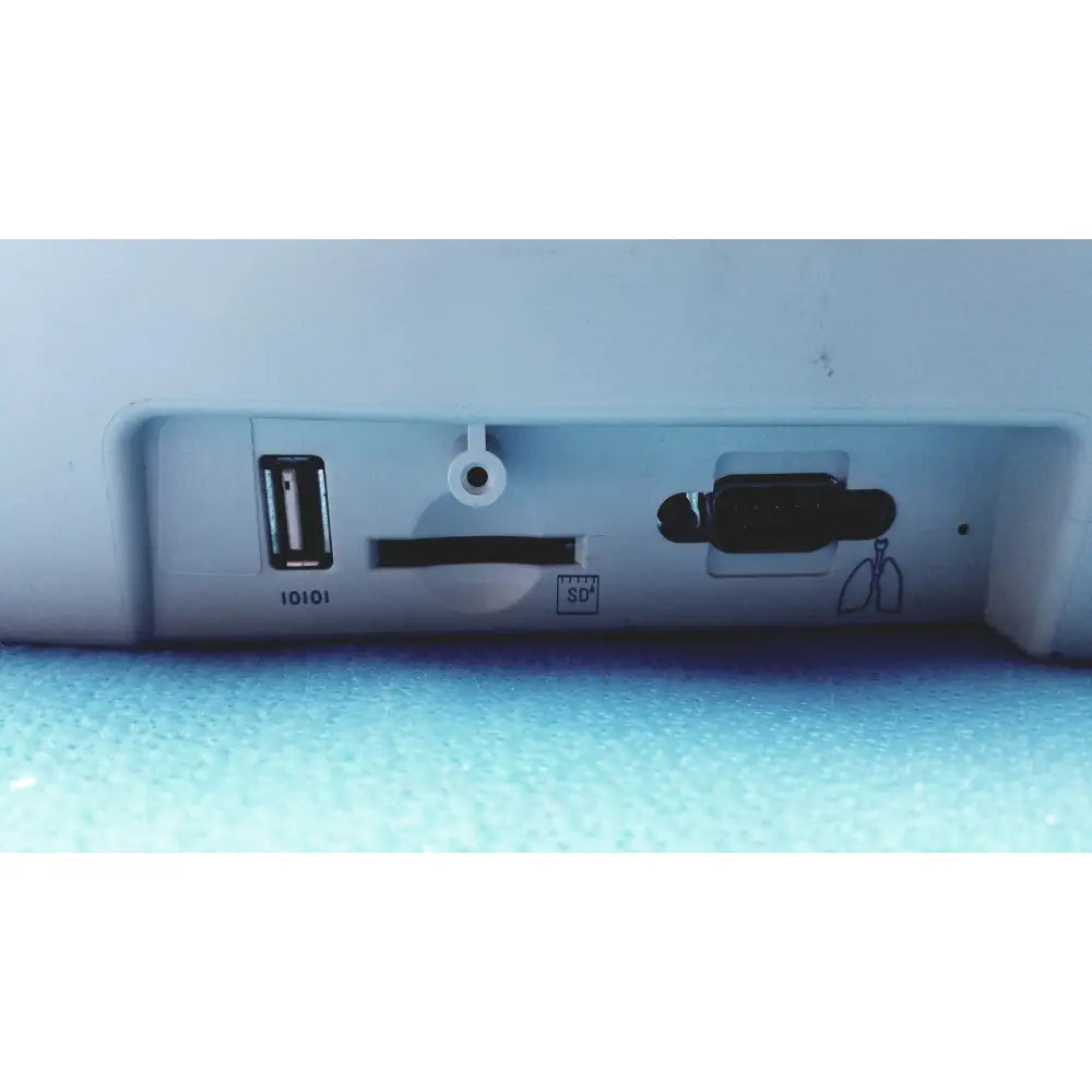 White plastic back side of welch allyn cp200 ekg monitor with usb port sd card slot and circular cable hole