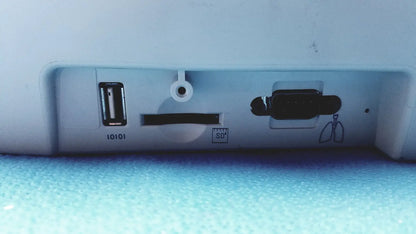 White plastic back side of welch allyn cp200 ekg monitor with usb port sd card slot and circular cable hole