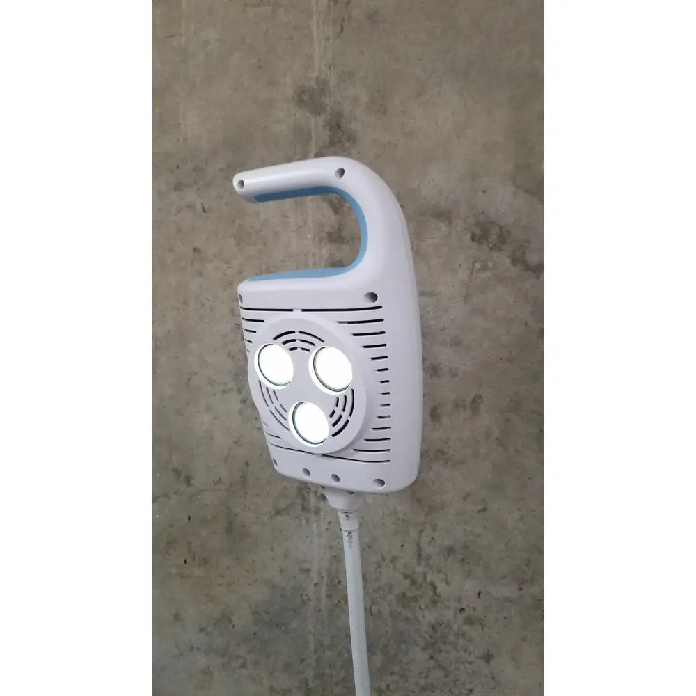 Welch Allyn GS 600 exam light handheld device in white and light blue with three circular lights on ventilated front panel on rolling stand