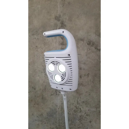 Welch Allyn GS 600 exam light handheld device in white and light blue with three circular lights on ventilated front panel on rolling stand