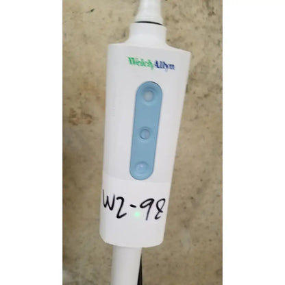 Welch allyn gs 600 exam light with rolling stand featuring white device, light blue control buttons, and a handwritten label