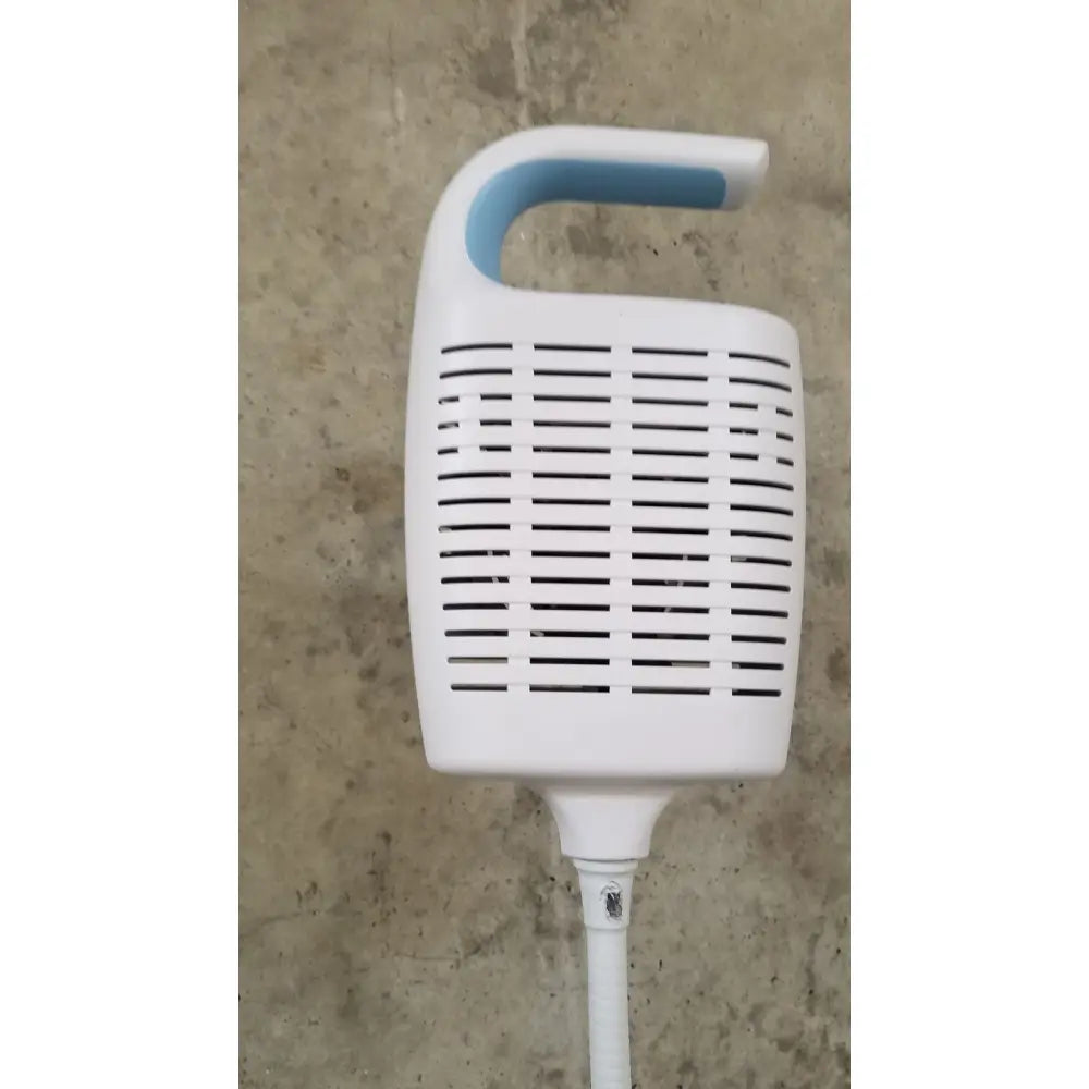 White plastic air purifier with blue handle and horizontal slats integrated on welch allyn gs 600 exam light rolling stand
