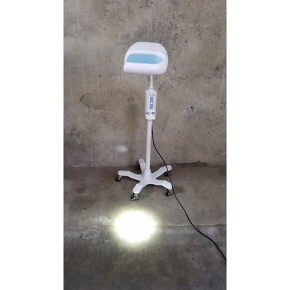 White adjustable salon chair with light blue illuminated seat panel and control unit next to welch allyn exam light rolling stand