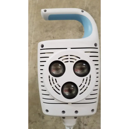 Welch allyn GS 600 exam light handheld device in white and light blue with three circular lenses and rolling stand