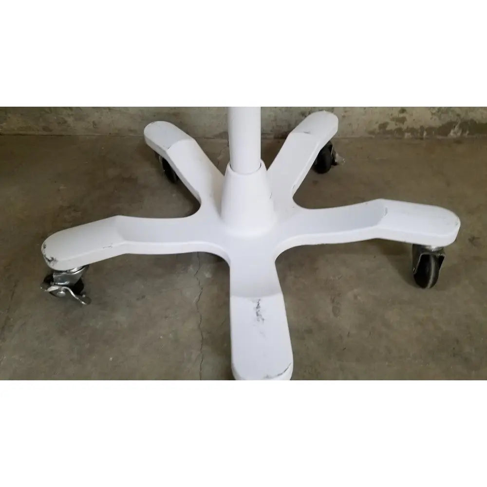 White plastic office chair base with black caster wheels on welch allyn gs 600 exam light rolling stand