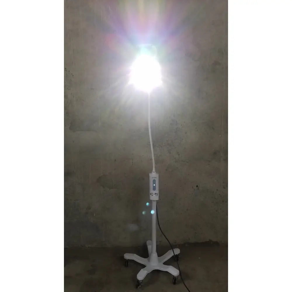 White Welch Allyn GS 600 exam light with adjustable arm and rolling stand for medical examination use