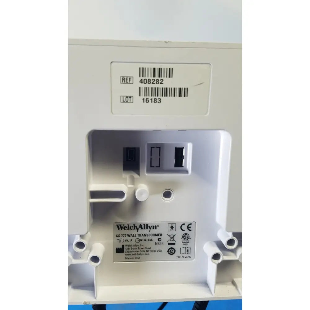 White plastic welch allyn gs 777 wall transformer with molded slots and label showing model and safety certifications