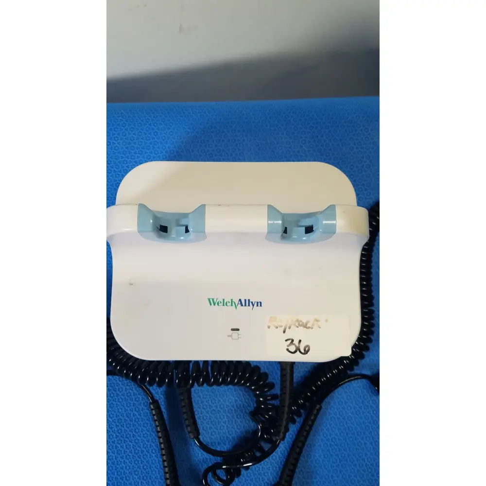 Welch allyn gs 777 wall transformer with white body light blue plastic grips and black coiled cords for reuse medical use