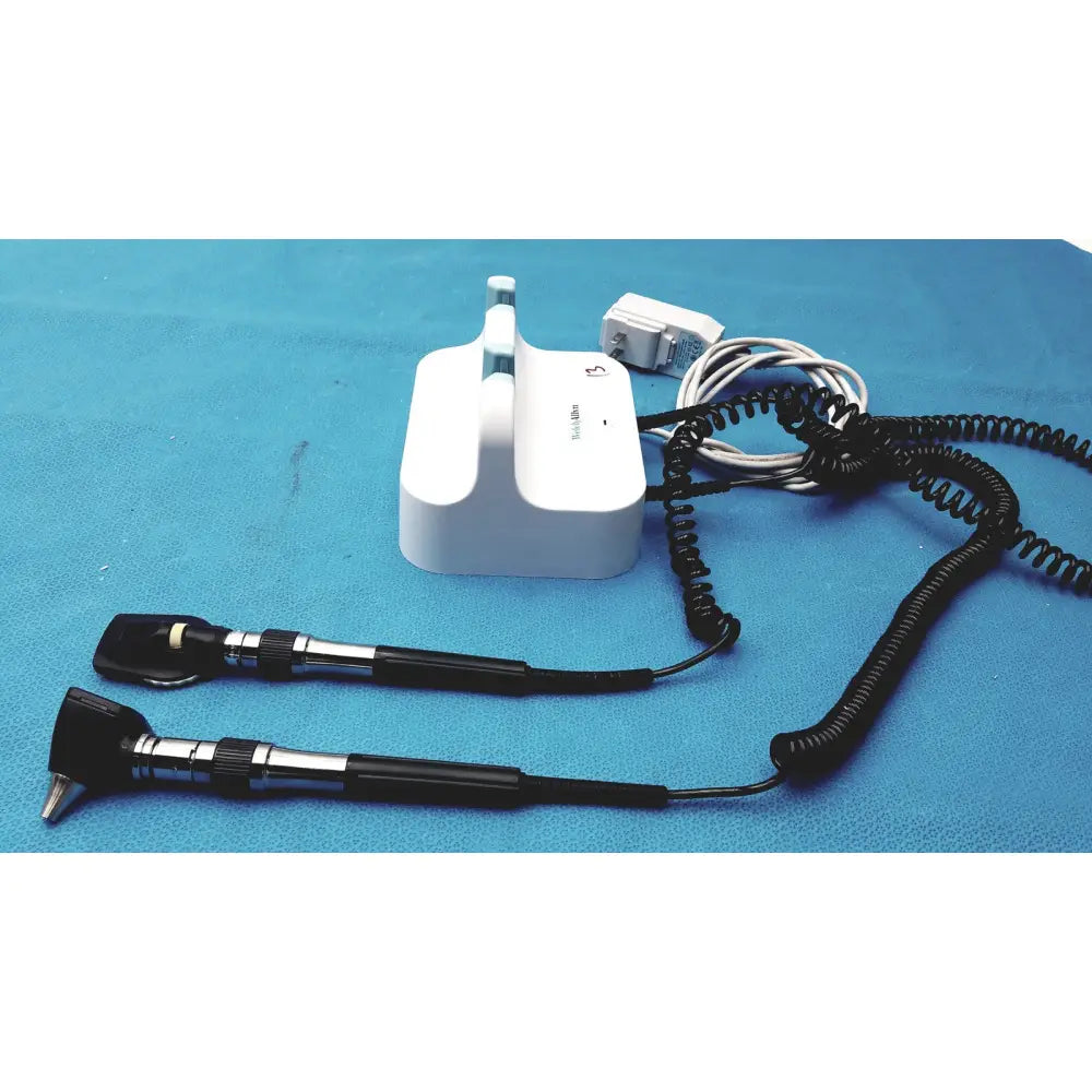 Welch allyn GS 777 wall transformer with white otoscope, black handles, and coiled cords for reuse medical use