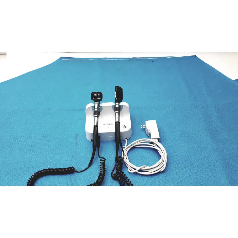 White medical otoscope with black handles and coiled cords for welch allyn wall transformer reuse medical use