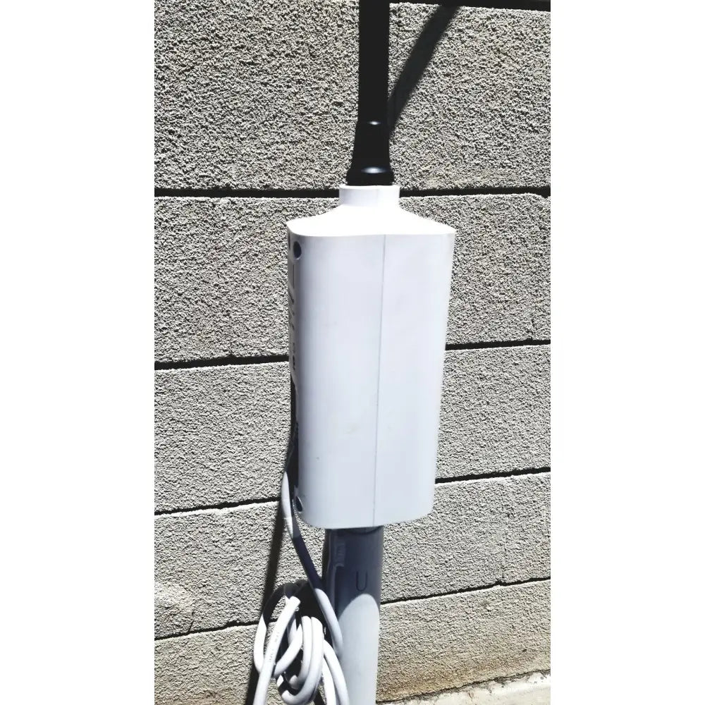White rectangular outdoor power outlet box mounted on pole for welch allyn gs exam light iv reuse medical setup