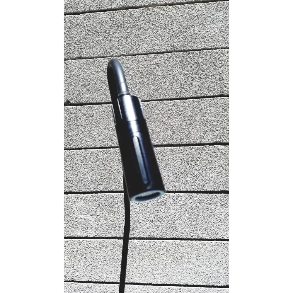 Black cylindrical welch allyn gs exam light iv with sleek modern design and textured grip for medical use