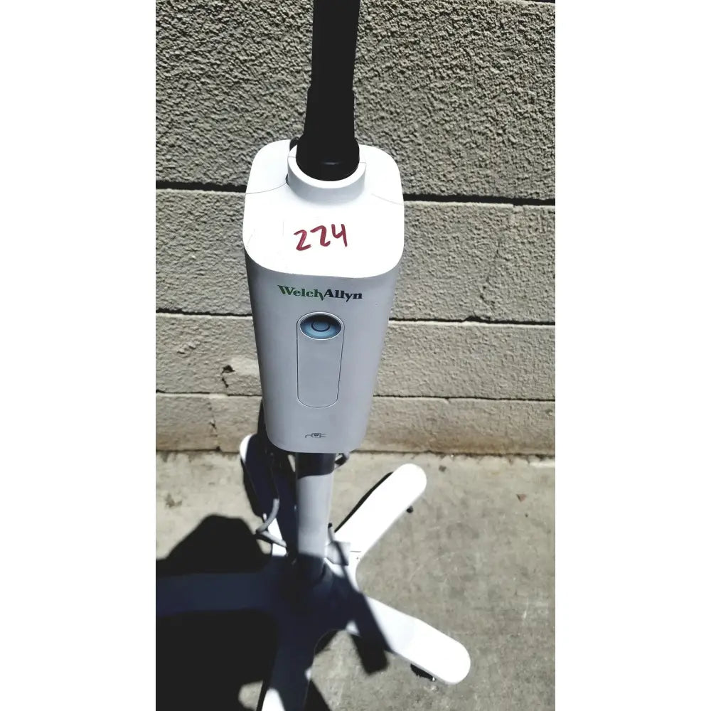 White welch allyn gs exam light iv with black pole and four white caster wheels for reuse medical settings