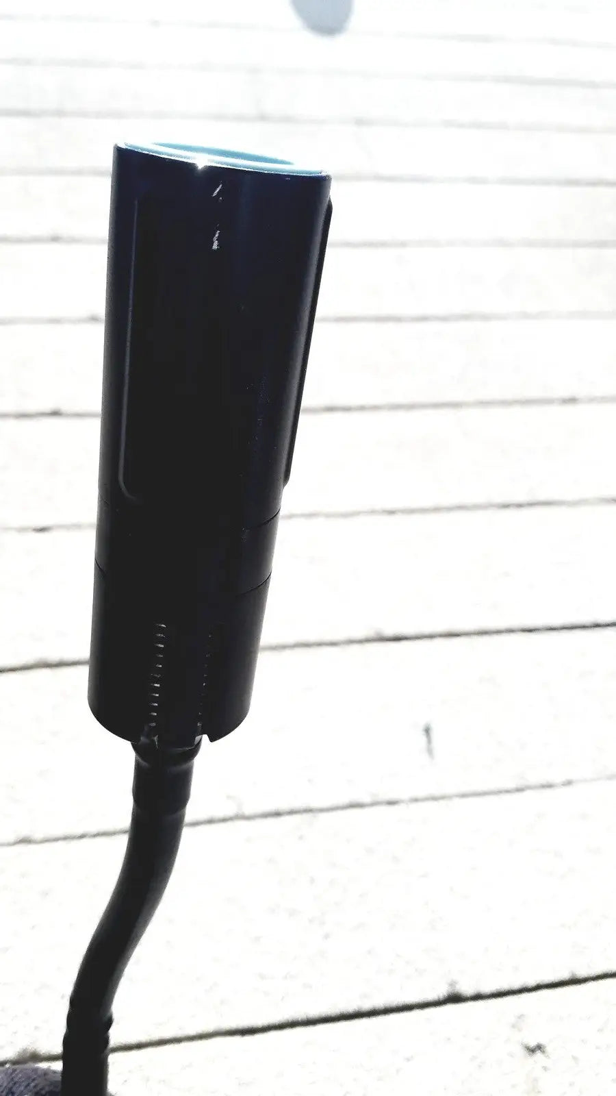 Black cylindrical welch allyn gs exam light iv with sleek modern design and curved base for efficient exam lighting