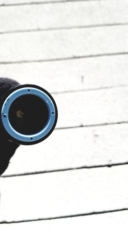 Blue and black circular camera lens of welch allyn gs exam light iv designed for reuse medical applications