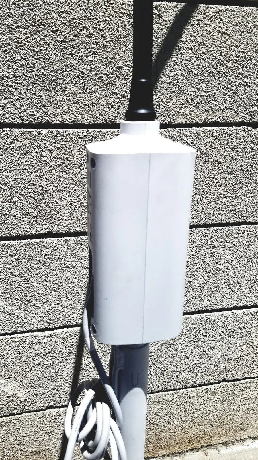 White rectangular outdoor power outlet box mounted on pole for welch allyn gs exam light iv reuse medical setup