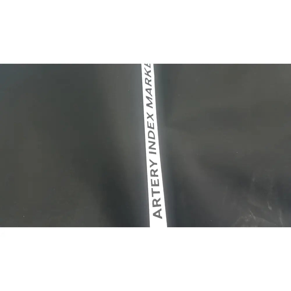 A sleek black artery index marker with bold white lettering on a welch allyn hillrom blood pressure cuff thigh 13