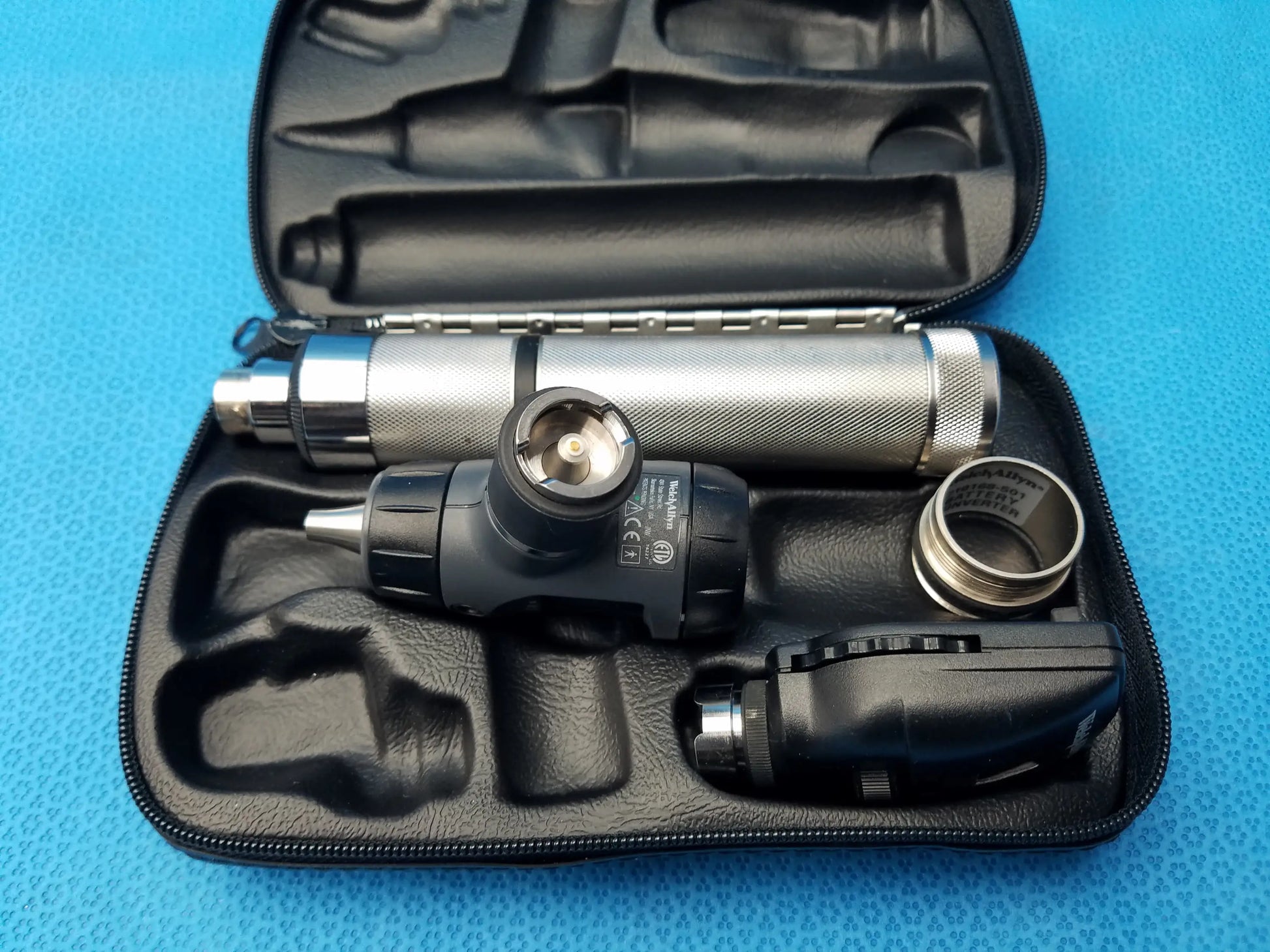Welch allyn led macroview otoscope kit with silver and black textured metallic body, ergonomic grip, and led illumination