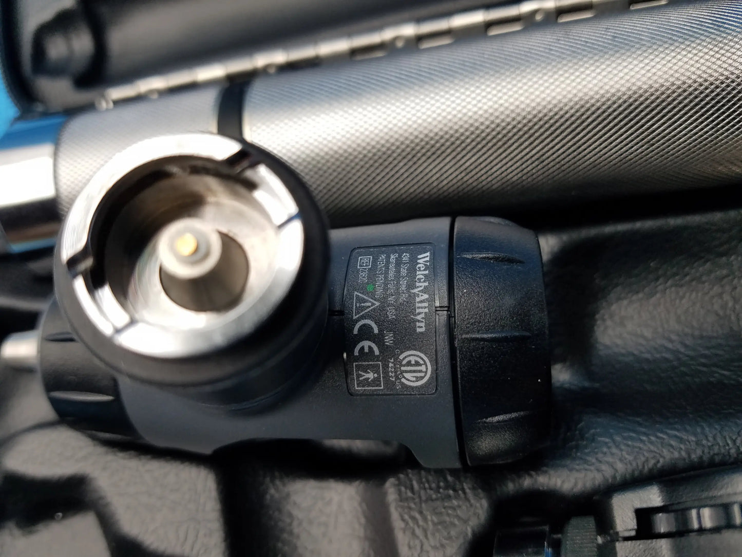 Black plastic Welch Allyn LED MacroView otoscope with textured grip and silver metallic head featuring led illumination