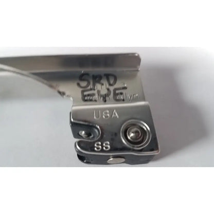 Silver metal presser foot with engraved markings and usa stamp on the back of a welch allyn miller laryngoscope blade size 3