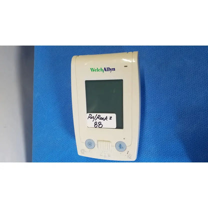 Cream-colored Welch Allyn ProBP 2400 digital blood pressure device with rectangular screen and two circular buttons below
