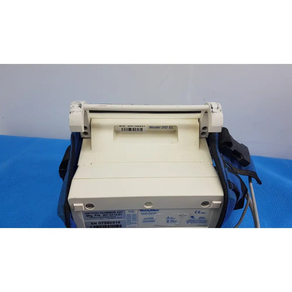 White plastic welch allyn propaq encore 202 el patient monitor with blue carrying strap for medical use