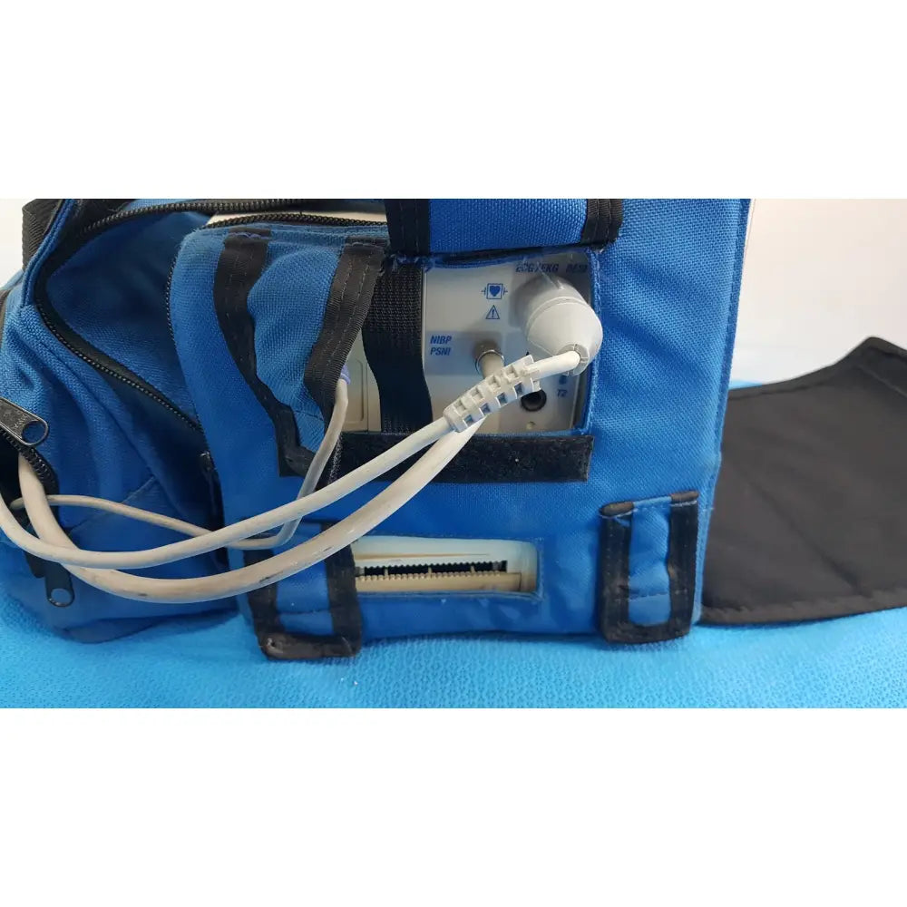 Blue fabric carrying case with black trim housing a white welch allyn propaq encore 202 el patient monitor with buttons and ports