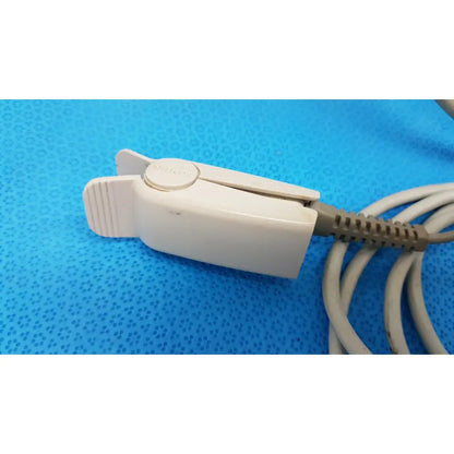 White plastic patient monitor clip with textured grip and nellcor button for welch allyn propaq encore series device
