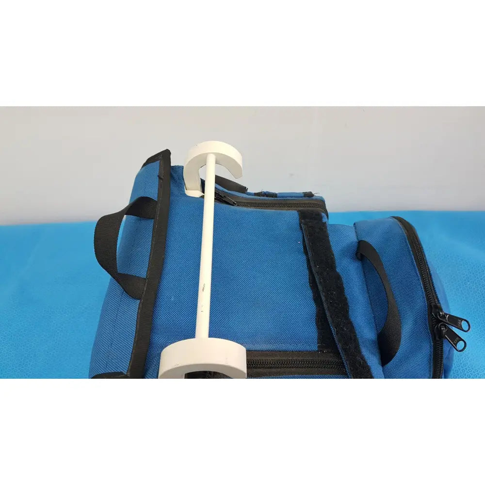 White plastic hanger with circular ends on blue fabric bag for welch allyn propaq encore patient monitor case