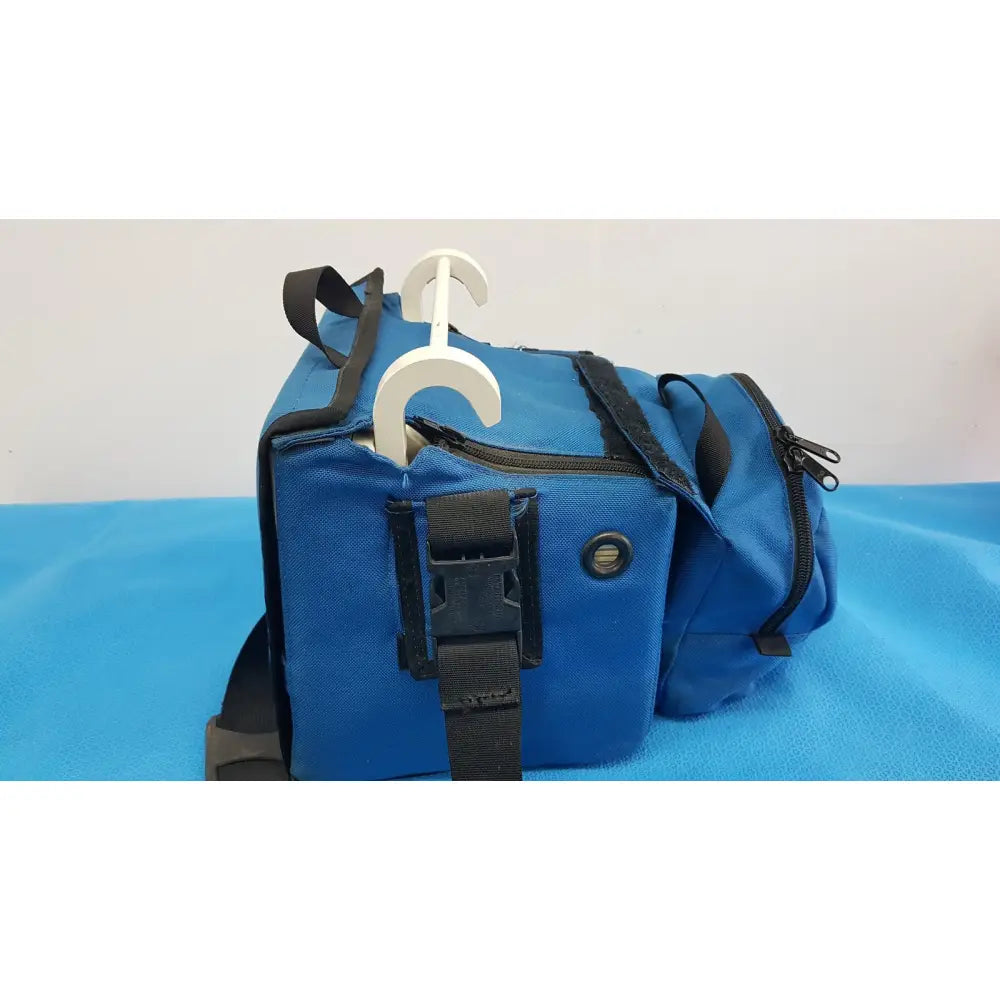 Blue fabric duffel bag with black zippers and straps and white plastic hanger for welch allyn propaq encore patient monitor