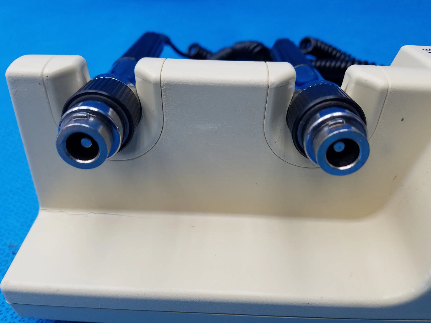 White plastic welch allyn diagnostic series transformer with two blue-tipped probes without heads for medical use