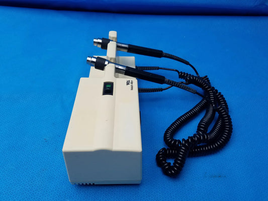 Cream-colored welch allyn diagnostic series transformer with two black-handled probes and green power indicator light