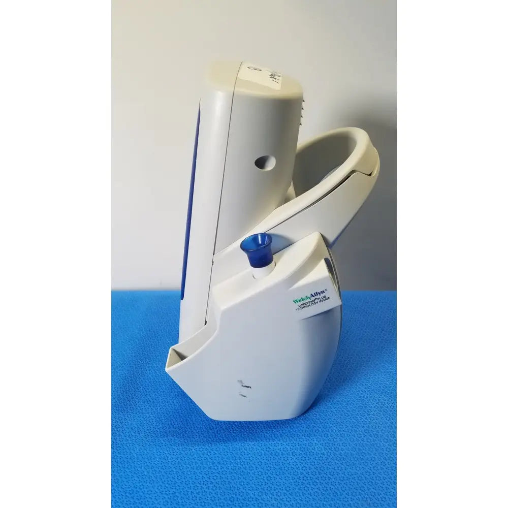 White plastic welch allyn spot vital blood pressure monitor with blue cap on cuff attachment point