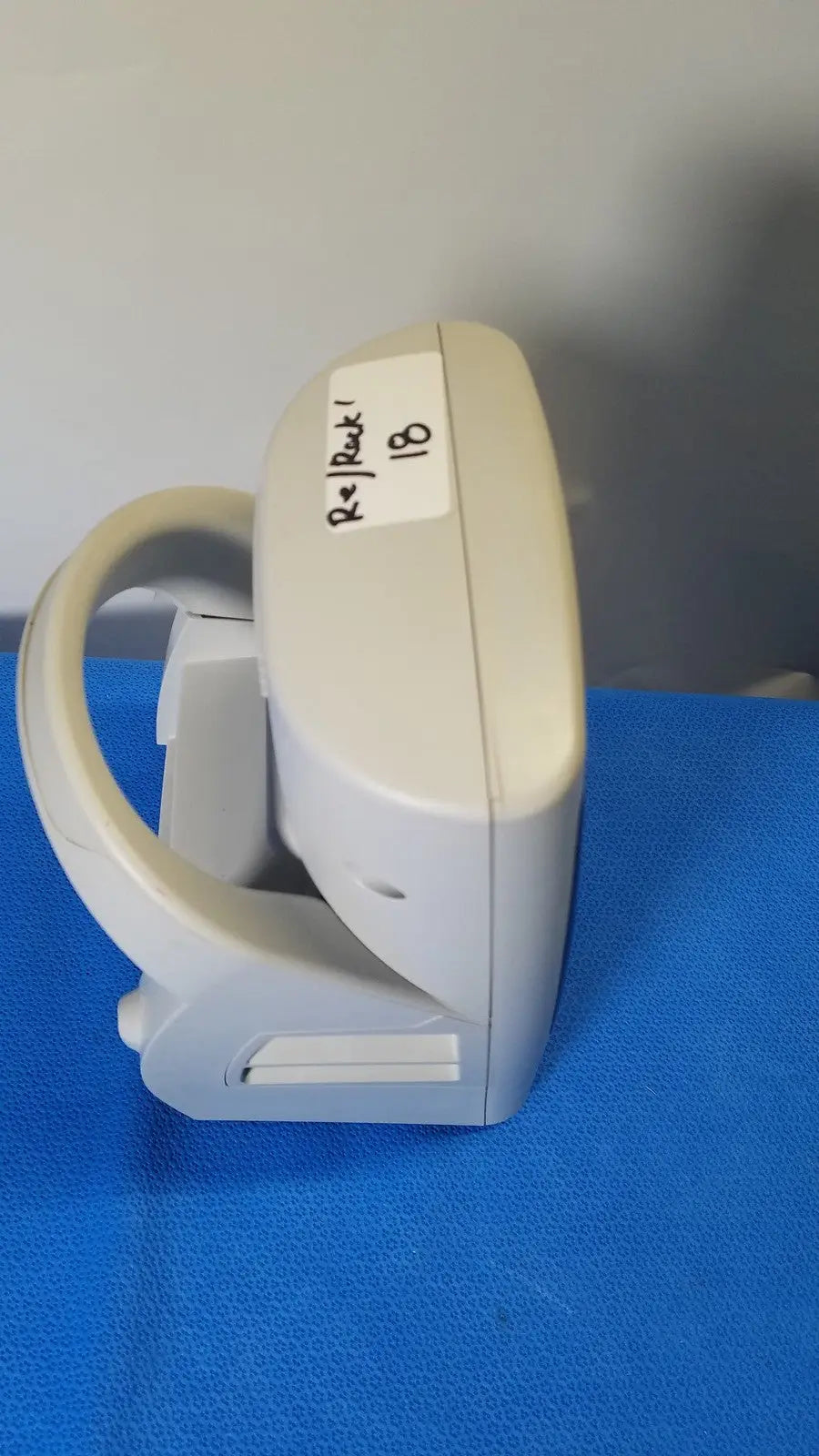 Beige plastic welch allyn spot vital signs lxi medical device with curved handle and labeled sticker for vital monitoring