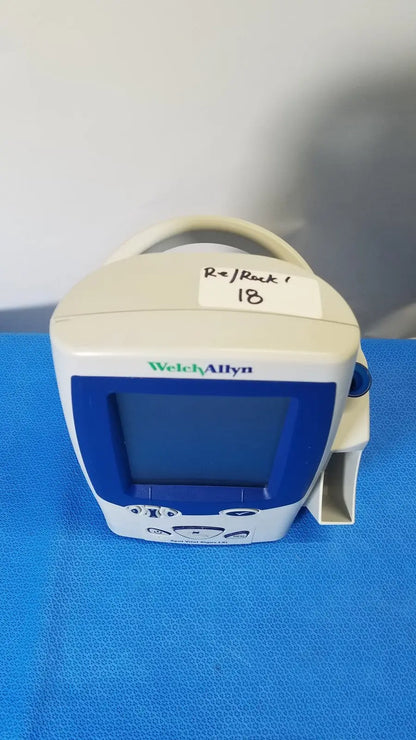 White and blue welch allyn spot vital signs LXi patient monitor with handle, screen, and control buttons