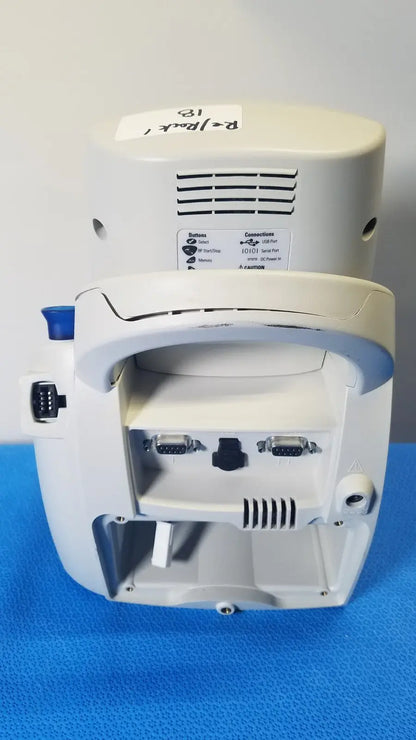 White welch allyn spot vital signs lxi medical monitor back side with curved handle and multiple ports visible