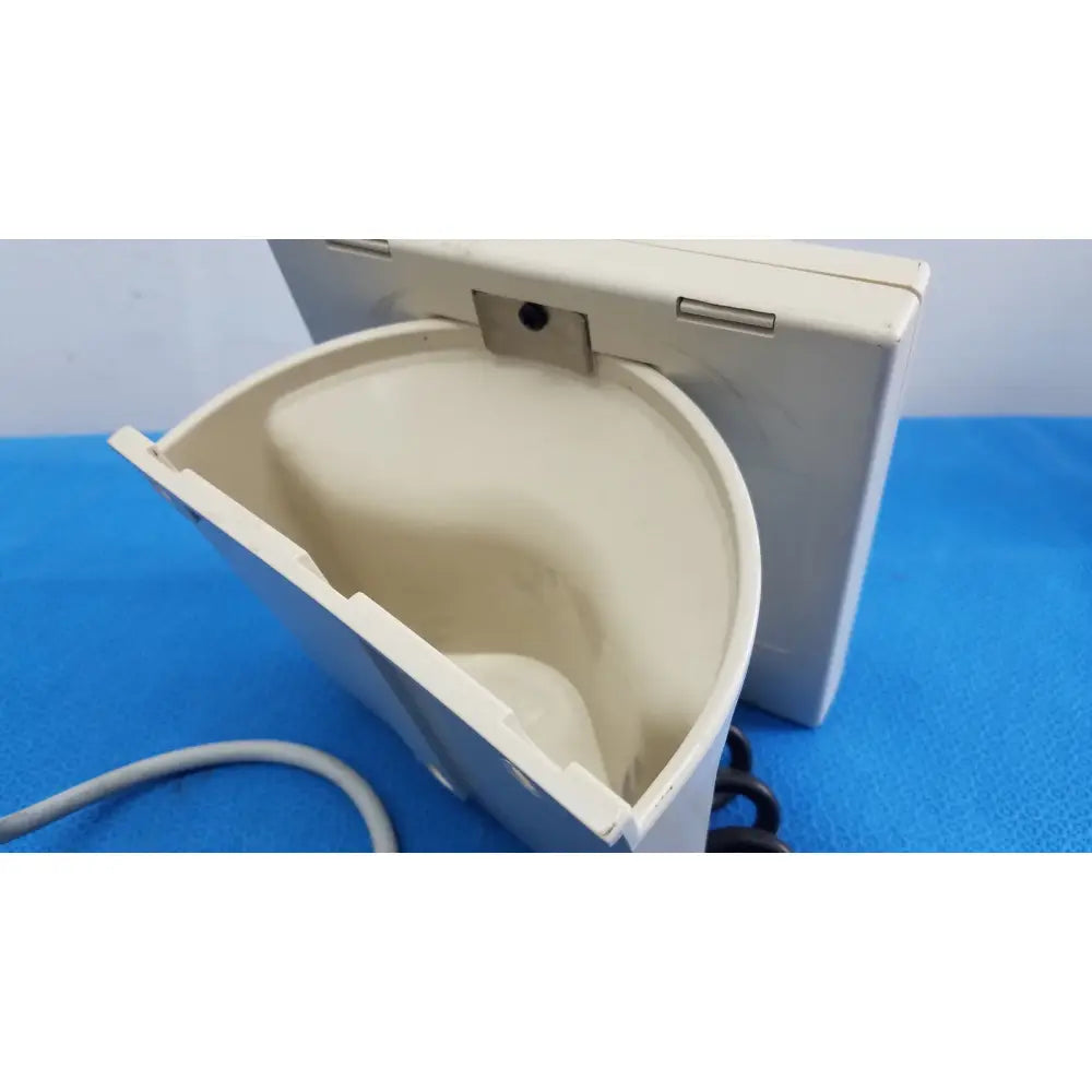 Beige plastic wall-mounted phone receiver with curved interior and hinge mechanism for welch allyn tycos mount aneroid gauge