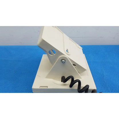 Off-white plastic allyn tycos mount with black coiled cable for welch allyn tycos tycos mount aneroid sphygmomanometer gauge